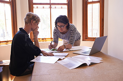 Buy stock photo A cropped shot of two focused women working together in a home office