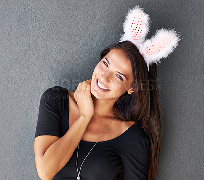 Buy stock photo Bunny ears, happy or portrait of woman with fashion or style isolated on wall or grey background. Easter holiday, lady or casual female person in studio with confidence, funny joke or trendy clothes