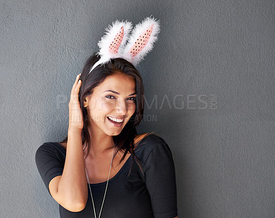 Buy stock photo Bunny ears, space or portrait of happy woman with fashion or style isolated on grey background. Model laughing, confident or casual female person in studio with smile, easter holiday or mock up