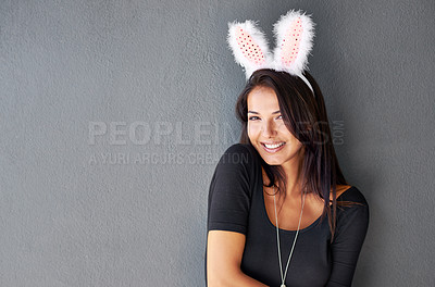 Buy stock photo Bunny ears, space or portrait of model with smile or style isolated on wall or grey background. Elegant woman, confident lady or casual female person in studio with fashion, funny joke or mock up