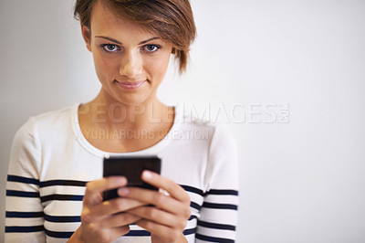 Buy stock photo Teen, studio or portrait with smartphone, texting and face for social media or communication. Girl, phone and smile with technology, online connection or internet message isolated on white background