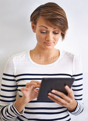 Buy stock photo Studio, tablet and woman with smile for social media on mobile with internet and network. White background, female person and girl with happiness for texting, typing and chat on app with technology