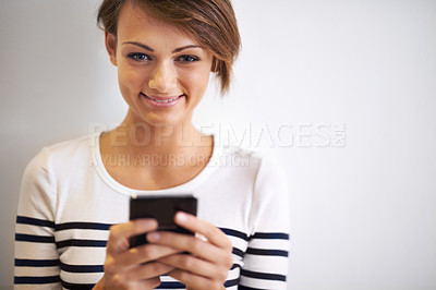 Buy stock photo Girl, studio or portrait with smartphone, texting and face for social media or communication. Teen, phone and smile with technology, online connection or internet message isolated on white background