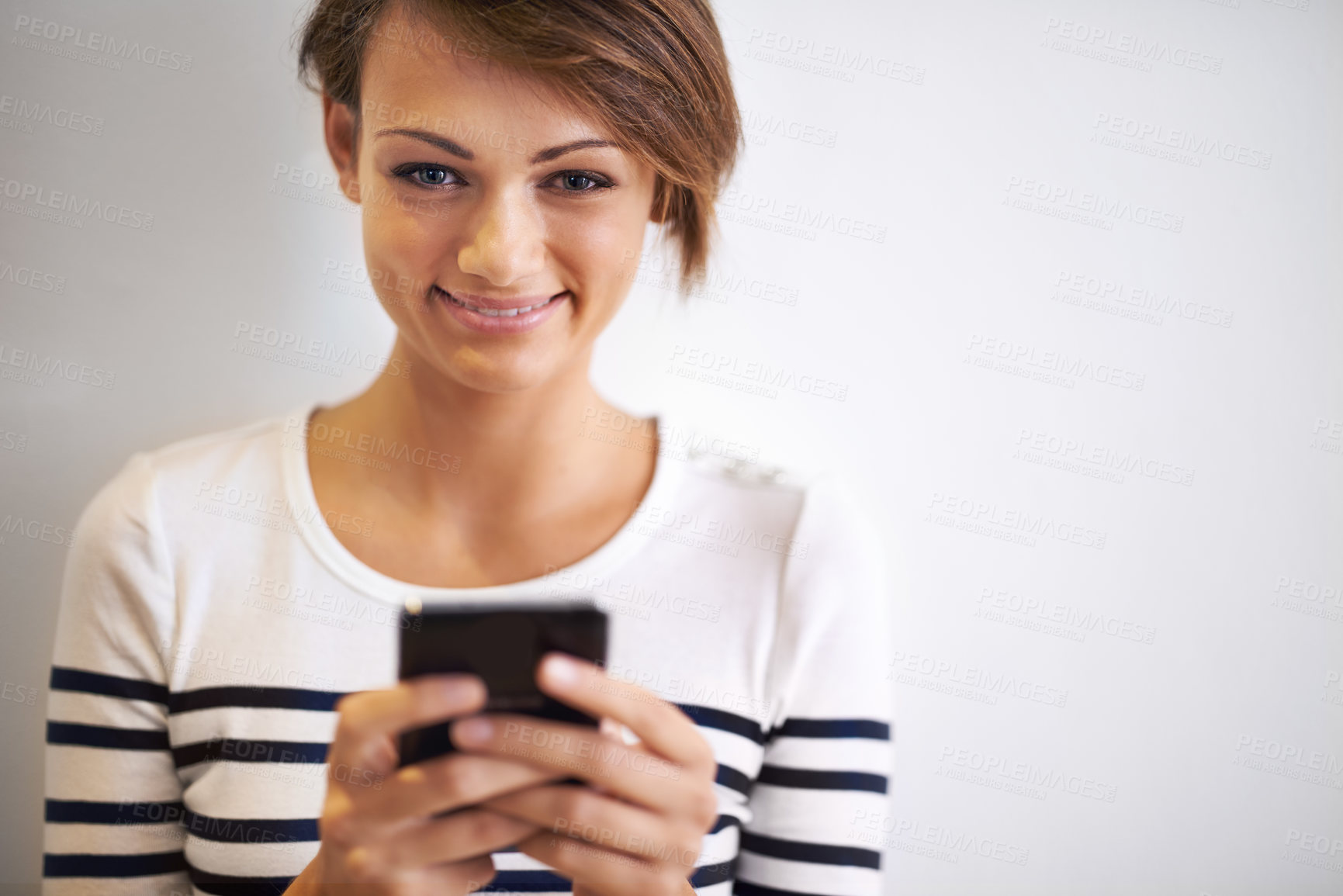 Buy stock photo Girl, studio or portrait with smartphone, texting and face for social media or communication. Teen, phone and smile with technology, online connection or internet message isolated on white background