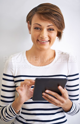 Buy stock photo Studio, tablet and portrait of woman with smile for social media on mobile with internet and network. White background, female person and girl with happiness for texting, typing and chat on app