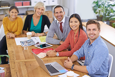 Buy stock photo Portrait of a group of colleagues sitting around a table