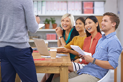 Buy stock photo A group of businesspeople listening to the speaker while sitting around a table