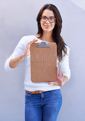 Buy stock photo Portrait, smile and woman with clipboard to show, empty and blank to support information or documents. Studio background, female person and girl with glasses for intelligence with single form holder