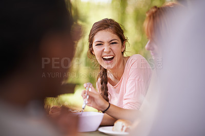 Buy stock photo Shot of teenage friends having a picnic at a table in the park