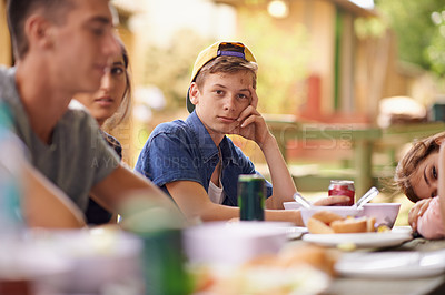 Buy stock photo Portrait, friends and eating lunch outdoor at party for celebration together at park in summer. Group, face and students with food at table in garden, drinking and serious teenager talking at picnic