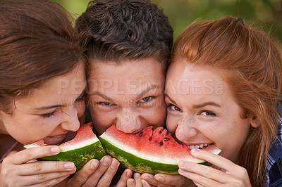 Buy stock photo Closeup shot of three young friends eating a watermelon together