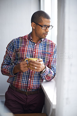 Buy stock photo Young, professional and confident black business man thinking of ideas for a project. Serious African American male on a break contemplating as he looks at the view from work during a coffee break