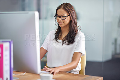 Buy stock photo A cropped shot of an attractive businesswoman working at her desk