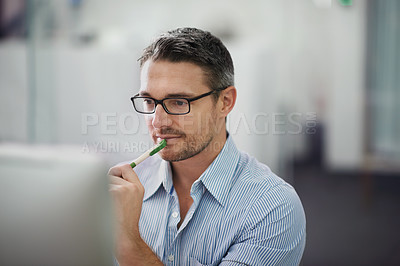 Buy stock photo Cropped shot of a businessman working at his desk