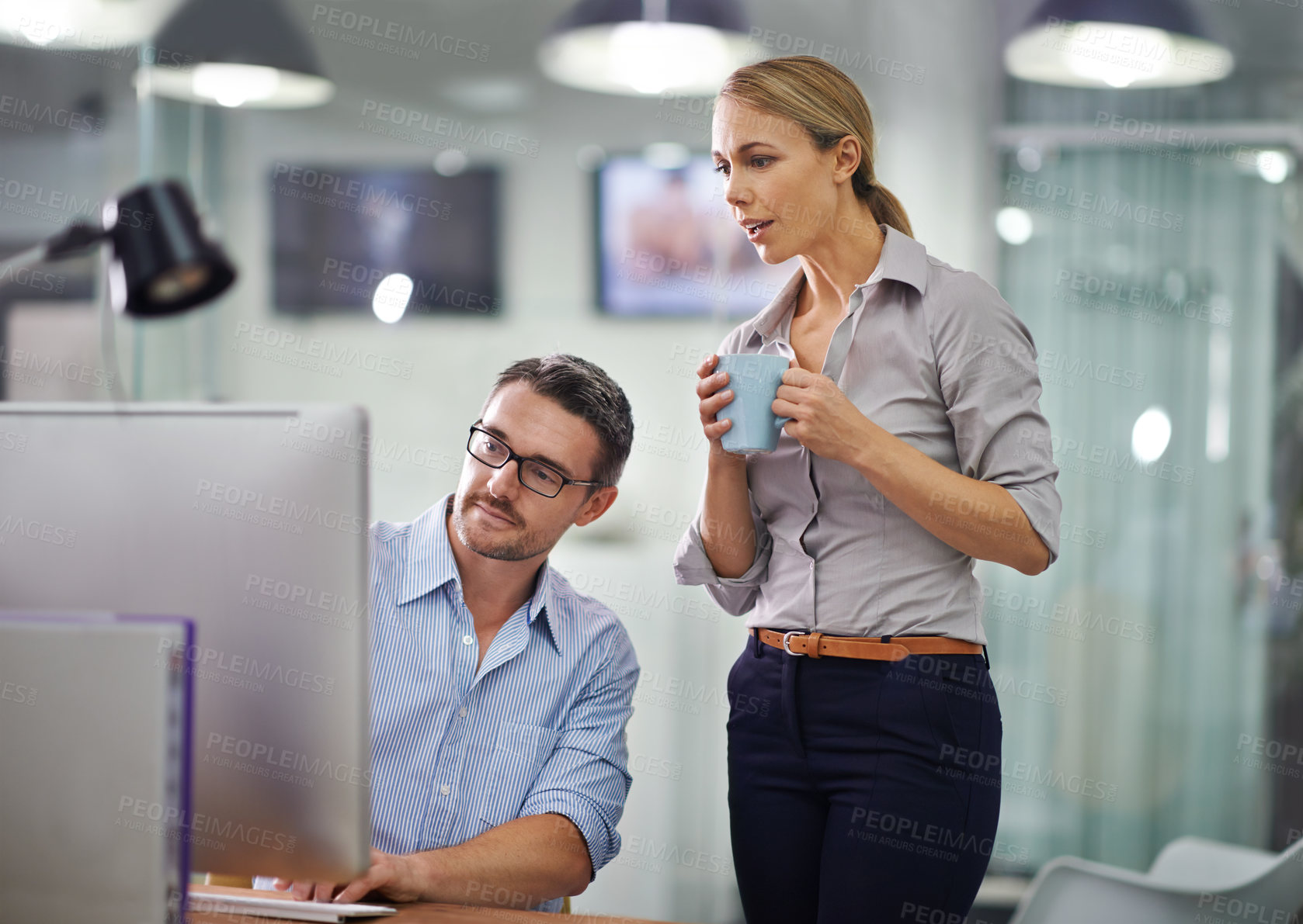 Buy stock photo Professional businesspeople developing strategy, share ideas and brainstorm in front of computers in the office space. Business colleagues analyzing data together and discussing a business plan