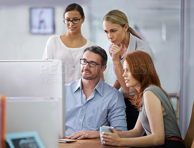 Buy stock photo Professional business people developing strategy, ideas and planning in front of a computer in the office space. Team of corporate workers analyzing data and discussing a business plan together