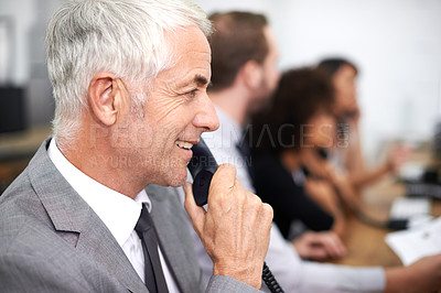 Buy stock photo Call center, man and landline in office for telemarketing with customer service, help desk and conversation. Senior, employee and happy consultant with telephone for support, telesales and advice