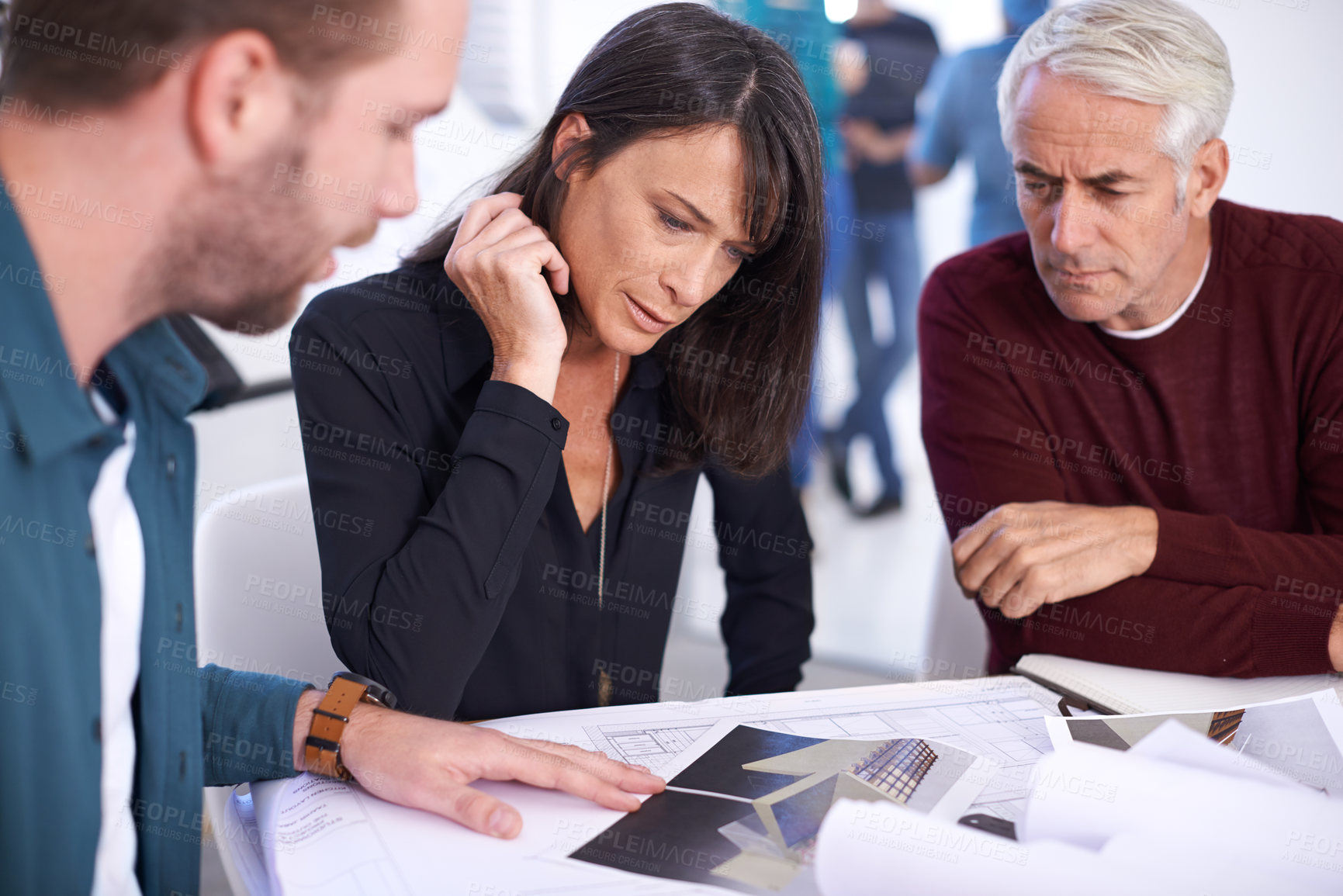 Buy stock photo Cropped shot of three architects working on a new building design
