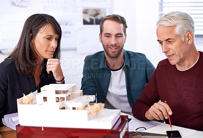 Buy stock photo Architects, teamwork and thinking with building model, 3d design and development with colleagues. Remodeling, construction and pointing in meeting, contractor or property developer for project