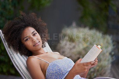 Buy stock photo African, woman and book at resort for relax, peace and chill on vacation. Happy, natural portrait of black female person reading in nature, retreat and on holiday for confidence in summer in dress
