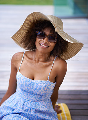 Buy stock photo Attractive ethnic female posing on the deck with her sun hat