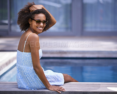 Buy stock photo African woman, outside and pool for vacation in summer, sitting and happy for trip with sunglasses. Holiday for relax and casual for swimming and happiness for wellness with natural female model