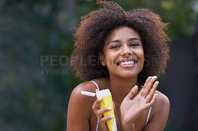 Buy stock photo African, woman and sunscreen happy in nature, body care or lotion for heat or sun protection with natural female person. Smiling, excited girl with product tube or summer fun on holiday retreat