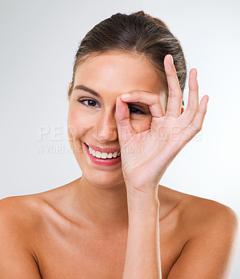 Buy stock photo Happy woman, portrait and beauty with ok sign for makeup, cosmetics or skincare on a gray studio background. Face of attractive female person, brunette or model with like emoji for facial treatment