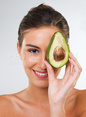 Buy stock photo Woman, portrait and avocado for health in studio for wellness detox, healthy skin or hydration with smile. Model, person or fruit for organic cosmetics, natural beauty or skincare on white background