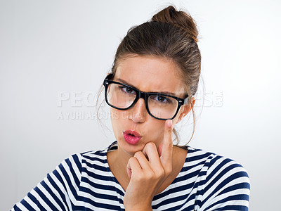 Buy stock photo Woman, glasses and expression for eyewear, watching and vision for thinking, idea and angry on white backdrop. Young person and finger on specs for crazy, annoyed and emotions with gesture and moody