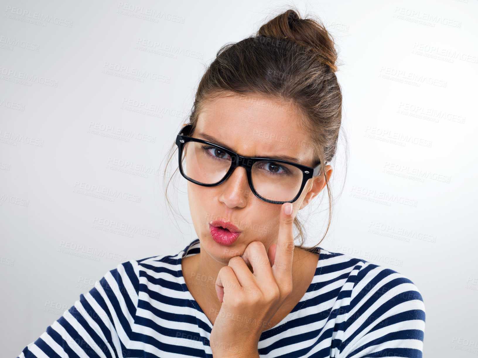 Buy stock photo Woman, glasses and expression for eyewear, watching and vision for thinking, idea and angry on white backdrop. Young person and finger on specs for crazy, annoyed and emotions with gesture and moody