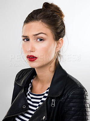 Buy stock photo Portrait of a beautiful young woman in a studio wearing a leather jacket