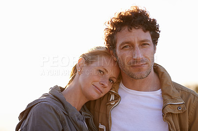 Buy stock photo A cropped portrait of a happy man and his wife standing affectionately outdoors