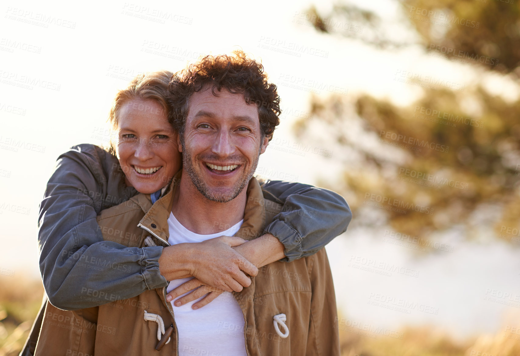 Buy stock photo Sunset, love and portrait of couple with smile for romantic date, bonding and vacation in nature. Man, woman and face with happiness for summer holiday, getaway and tourism together at countryside