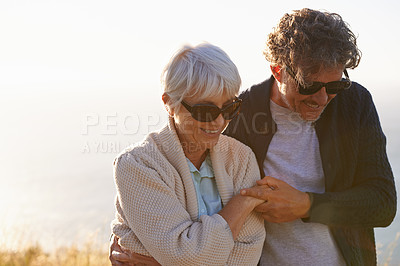 Buy stock photo Smile, field and elderly couple in nature for travel, sunset walk or retirement holiday together. Coast, hill and senior people with happiness for tourism, summer vacation and bonding in California