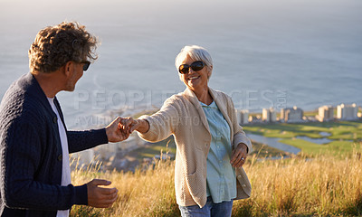 Buy stock photo Happy, vacation and couple outdoor in dance on hill or mountain in Cape Town and holding hands with love. Mature, people and embrace with kindness on holiday adventure in nature and relax together