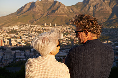 Buy stock photo View of a senior couple standing on a hillside together