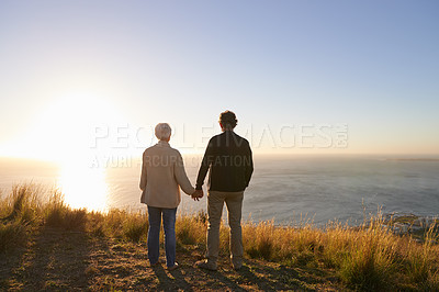 Buy stock photo View of a senior couple standing on a hillside together