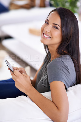 Buy stock photo Woman, couch and phone for portrait on social media in home, comfortable and web for entertainment. Female person, smile and app for blog and subscription, lounge and relax on sofa for communication