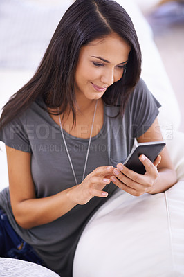 Buy stock photo Woman, couch and phone app for communication in home, comfortable and website for entertainment. Female person, smile and app for blog and subscription, living room and relax on sofa for texting