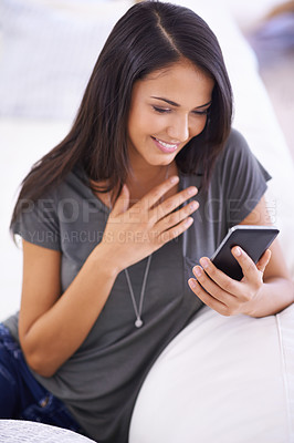 Buy stock photo Woman, living room and sofa with smile on smartphone  for online research or social media with networking. Female person, home and touchscreen on break for internet, video and entertainment.