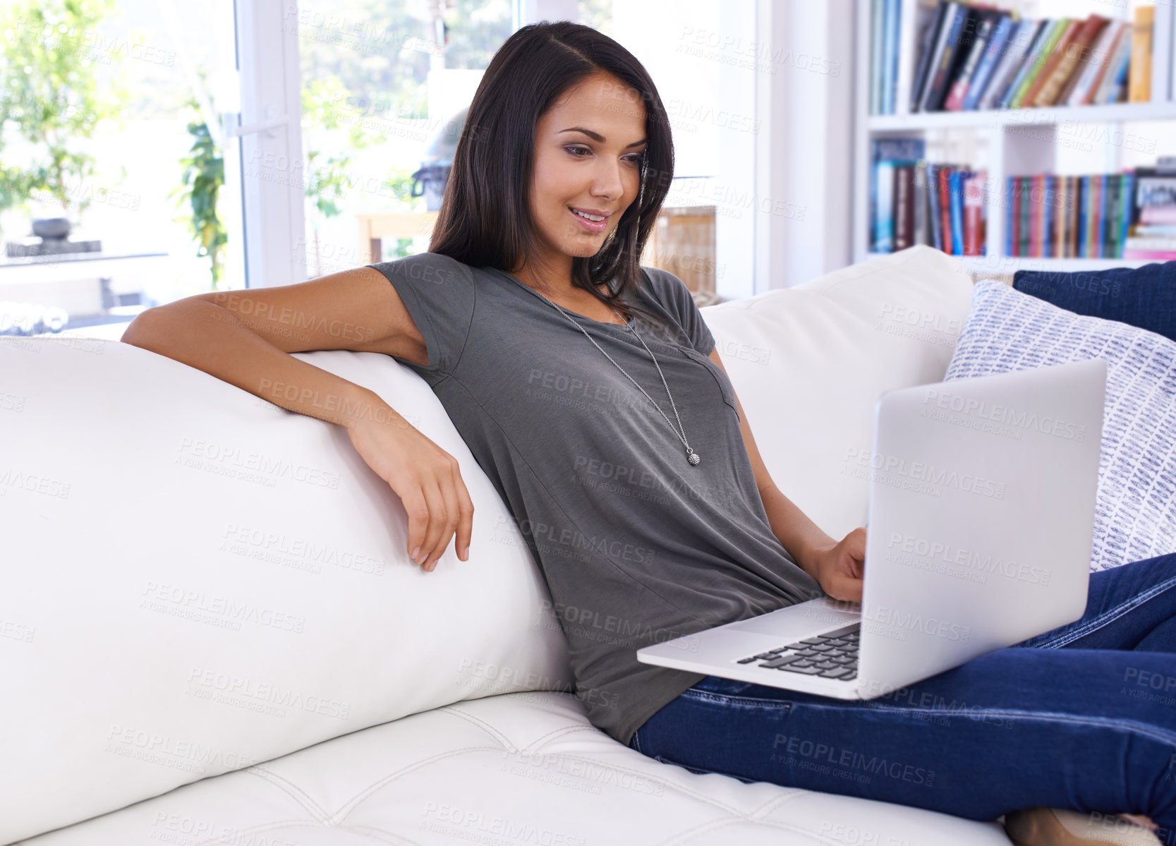 Buy stock photo Woman, laptop and happy in home for relax with typing email, communication and online research in living room. Person, technology and social media search, web subscription and writing blog on couch