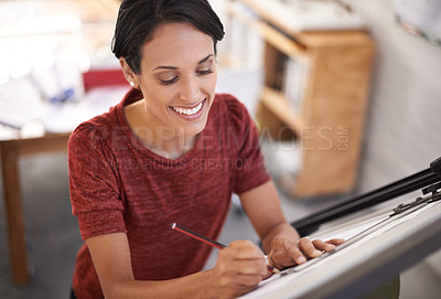 Buy stock photo Shot of an attractive young architect working in her office