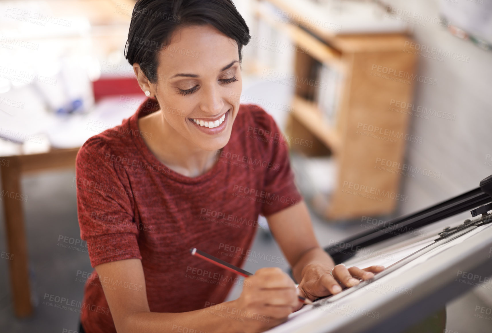 Buy stock photo Shot of an attractive young architect working in her office