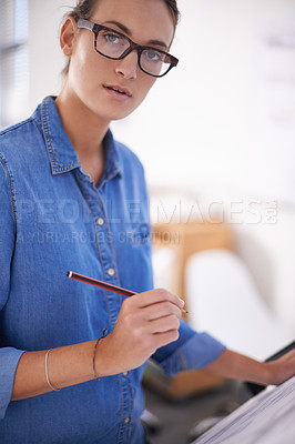 Buy stock photo Shot of an attractive architect working on blueprints