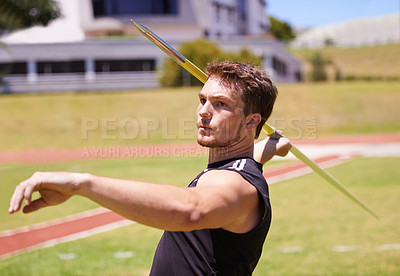 Buy stock photo Shot of a lone man throwing a javelin outside