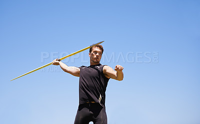 Buy stock photo Shot of a lone man throwing a javelin outside