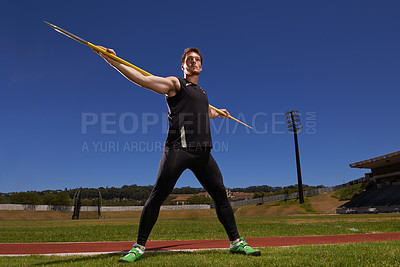 Buy stock photo Shot of a lone man throwing a javelin outside