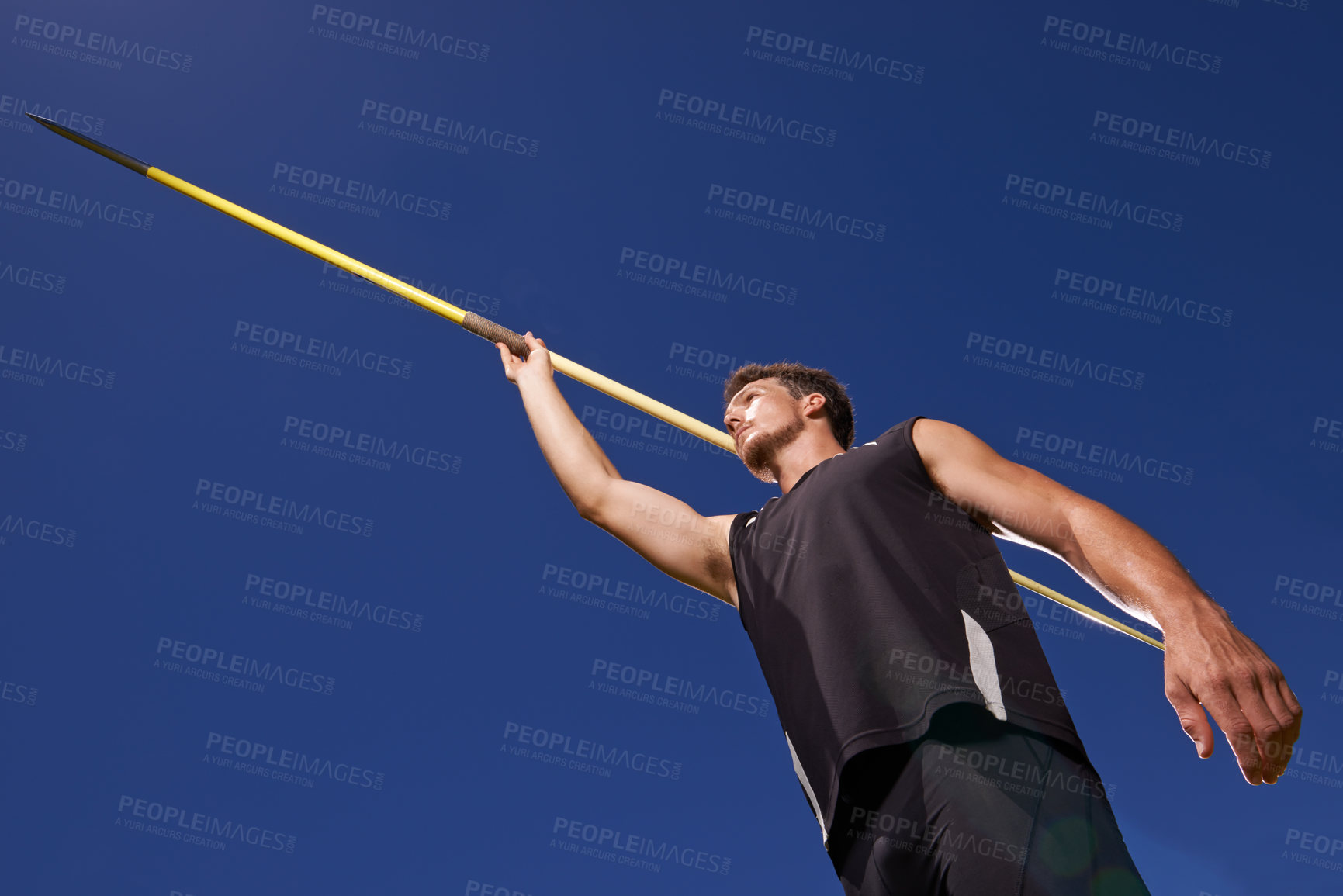 Buy stock photo Shot of a lone man throwing a javelin outside