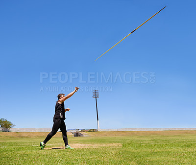 Buy stock photo Shot of a lone man throwing a javelin outside